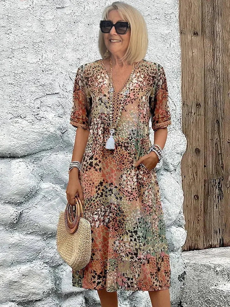 Beige and terracotta tonal print V-neck dress with a gathered waist and knee-length hem