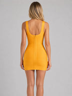 Back view of golden yellow bandage mini dress showing scoop back and centre zip closure