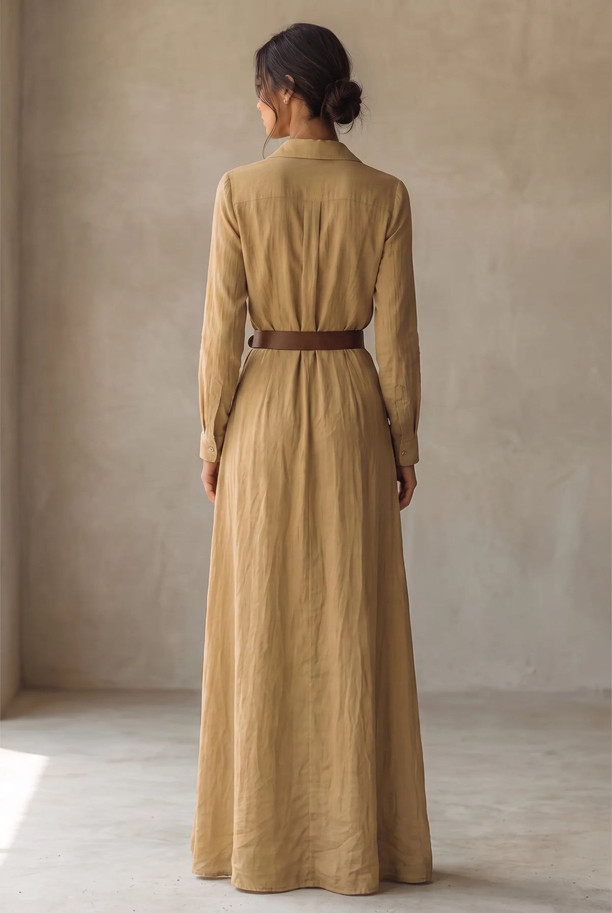 Back view of the khaki maxi dress showing the collared yoke, long sleeves and thin brown belt at the waist