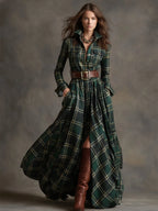 Side angle of the pleated tartan maxi skirt swaying with visible front slit and leather boots