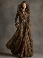 Full-body studio shot of the belted tartan maxi shirt dress styled with a gold chain necklace and boots