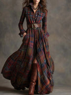 Front view of a red and navy plaid maxi shirt dress cinched with a wide brown belt, worn with boots