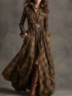 Close-up of chest pocket detail and brass button closure on the plaid shirt dress bodice