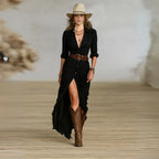 Front view of black long-sleeve belted shirt dress with deep button placket, leg slit and brown leather waist belt