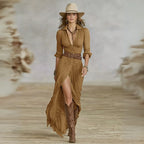 Brown belted shirt dress with gathered bodice, rolled sleeves and buckled belt, styled with tall western-style boots