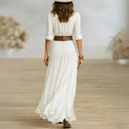Back view of white belted maxi shirt dress showing wide leather belt, gathered waist and flowing skirt silhouette