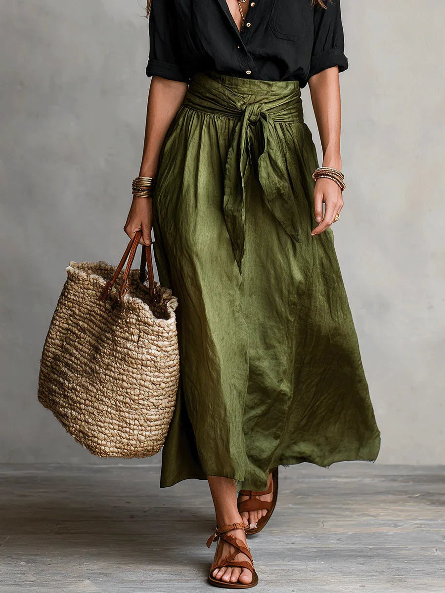 Front detail shot of the olive green skirt's gathered waistband and tie-front bow closure