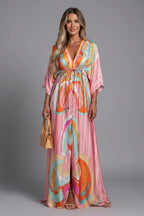 Model wearing the pink colourway of the printed maxi dress with button placket, drawstring waist and front slit