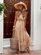 Close-up front view of a beige maxi dress highlighting the crochet lace bodice and gold polka dot chiffon skirt.