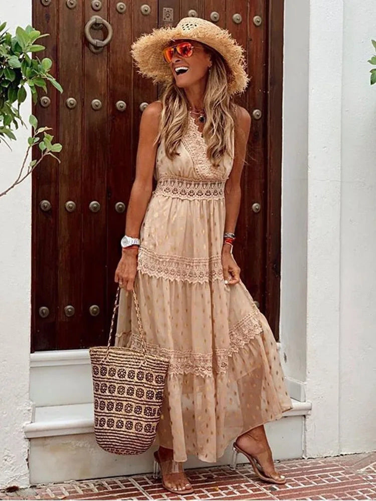 Close-up front view of a beige maxi dress highlighting the crochet lace bodice and gold polka dot chiffon skirt.