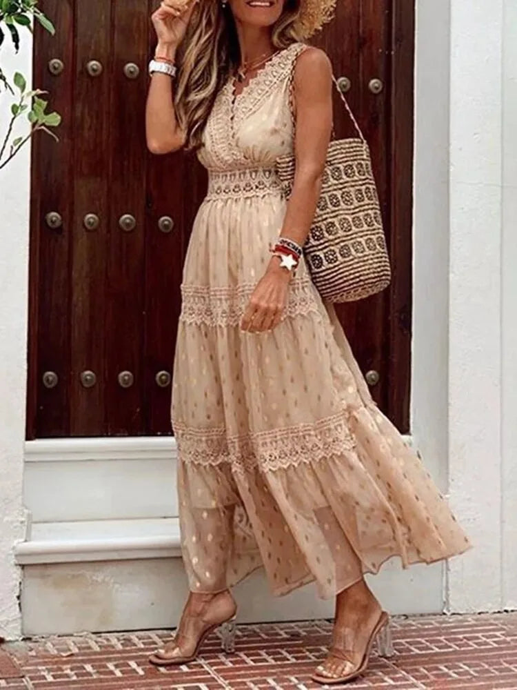 Close-up of the beige dress's V-neckline, lace waistband and flowing tiered skirt paired with clear block heels.