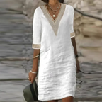 White boho midi dress with crochet V-neck trim, half sleeves and lace cuff detail, worn with layered necklaces