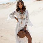 Close-up of the lace dress bodice featuring pom-pom and bead trim at the neckline, paired with a woven round bag