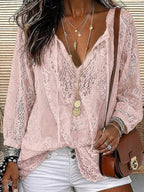 Close-up of pink lace blouse with scalloped hem, worn open over white denim shorts with layered gold necklaces