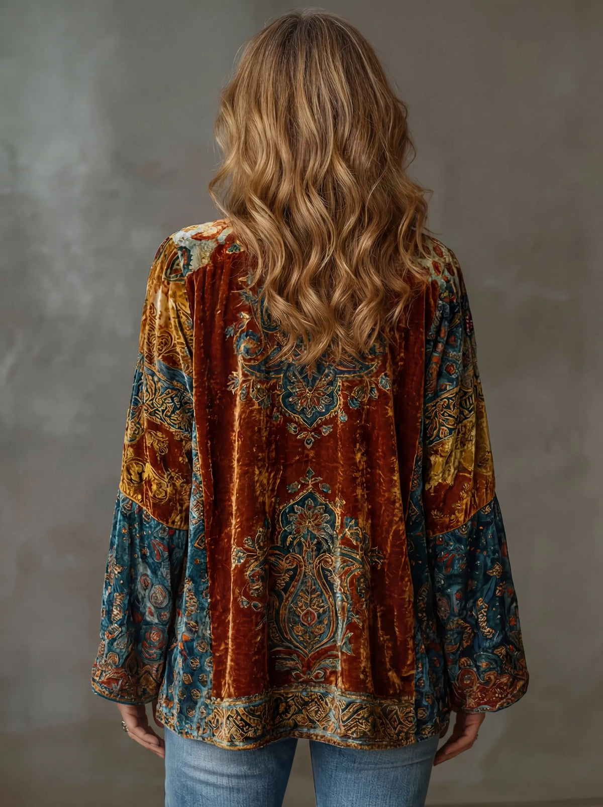 Back view of the rust and teal velvet kimono jacket showing the detailed paisley medallion pattern across the shoulders