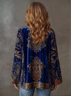 Back view of the midnight blue velvet kimono jacket highlighting the gold embroidered paisley motifs and wide sleeves