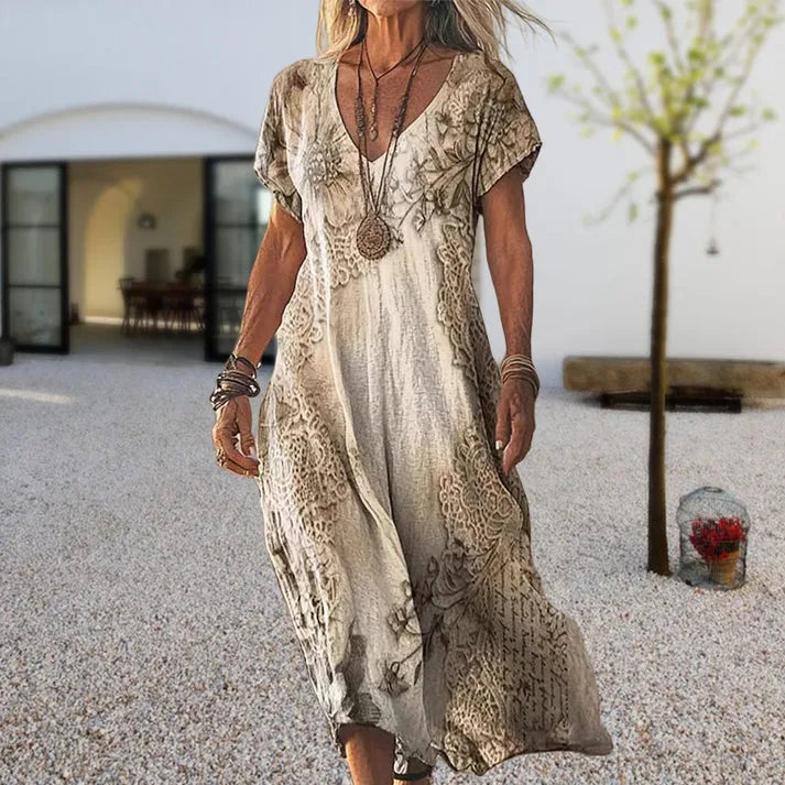Front view of the maxi dress in a beige floral and lace-print design with short sleeves and V-neckline