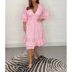 Pink broderie anglaise midi dress with cinched waist and flowing A-line skirt, front-facing view