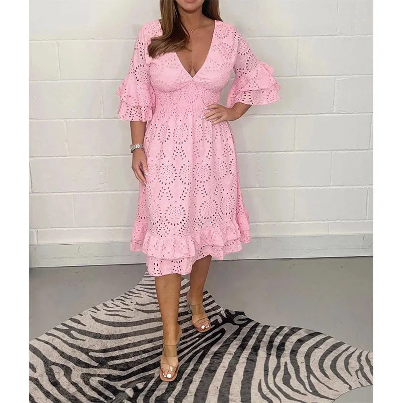 Pink broderie anglaise midi dress with cinched waist and flowing A-line skirt, front-facing view
