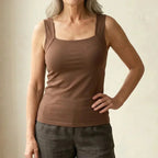 Front view of a woman wearing a brown square-neck built-in bra tank top with grey linen-style pants