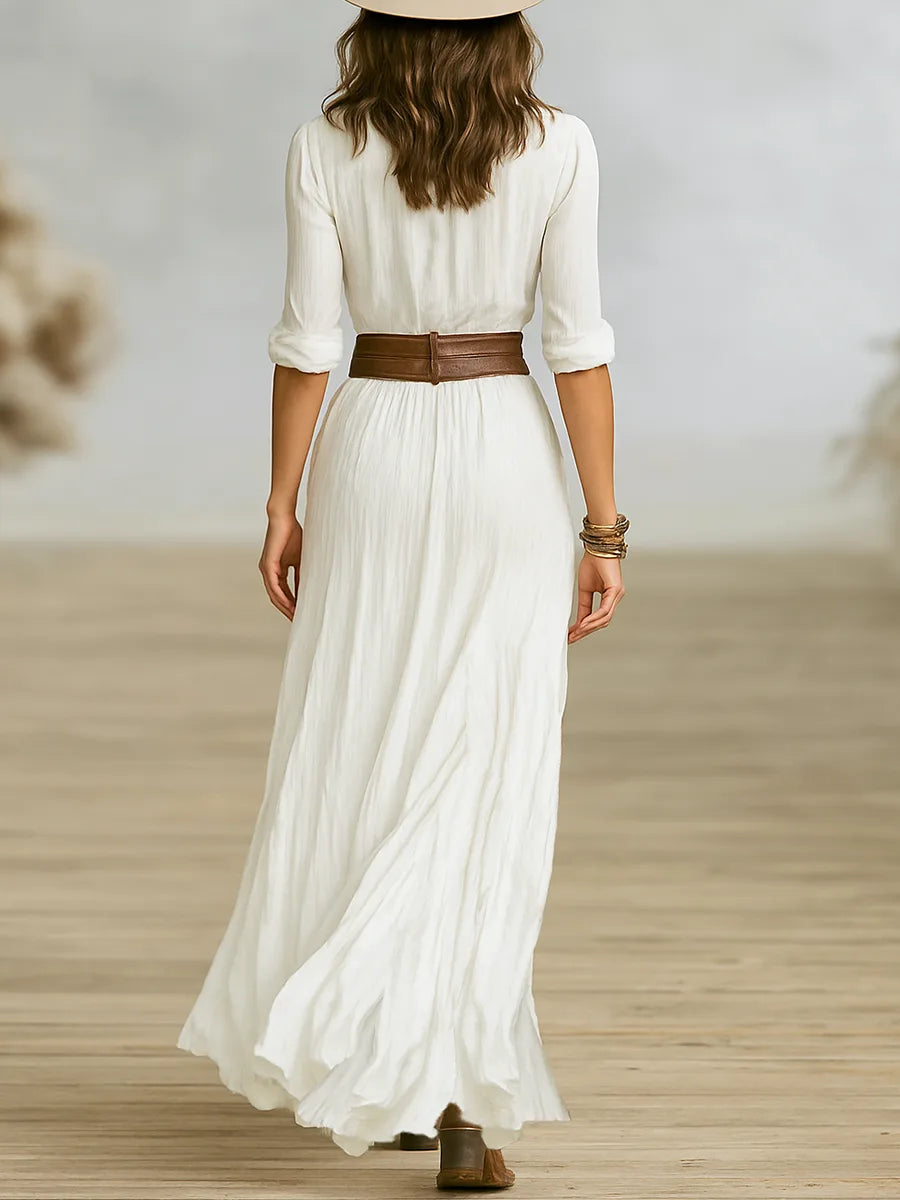 Back view of white maxi shirt dress showing gathered waist, brown leather belt and full flowing skirt sweeping the floor