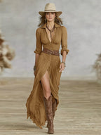 Front view of the maxi shirt dress in camel brown with puff sleeves, deep V neckline, belted waist and embroidered boots
