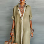 Close-up of the khaki shirt dress showing the collared neckline, button placket and rolled short sleeves