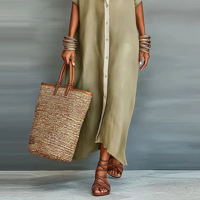 Close-up of the khaki shirt dress fabric with button detail, paired with a woven tote and strappy sandals