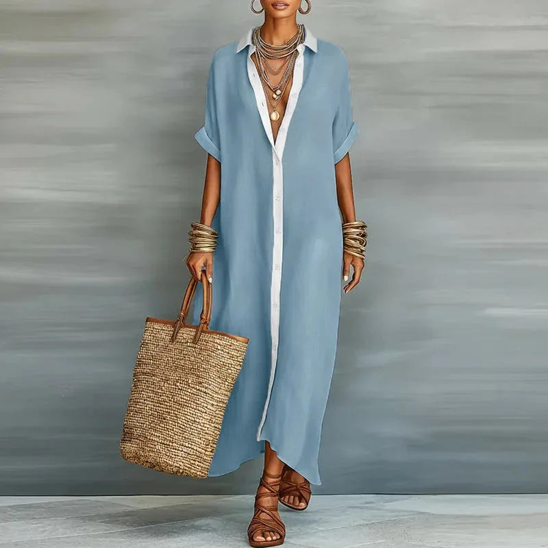 Model wearing a light blue maxi shirt dress with white contrast collar and button placket, front view