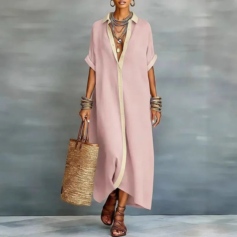 Model wearing a pink maxi shirt dress with contrast tan collar and placket, paired with strappy sandals