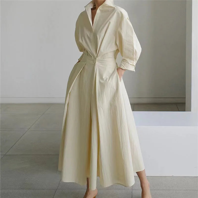 Side profile view showing the cinched waist shape and bishop sleeve of the maxi shirt dress