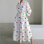 White maxi shirt dress covered in multicolour polka dots with collar and gathered waist detail
