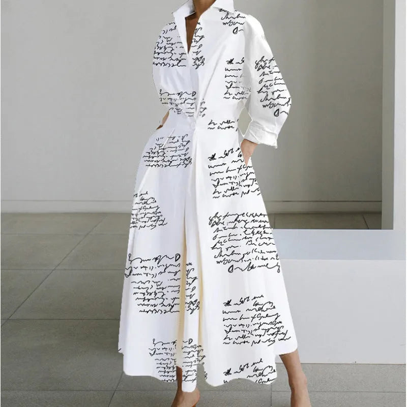 White maxi shirt dress printed with black handwritten script, collared V-neck and pockets