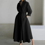 Close side view of the waist tie and gathered front wrap detail on a printed maxi shirt dress