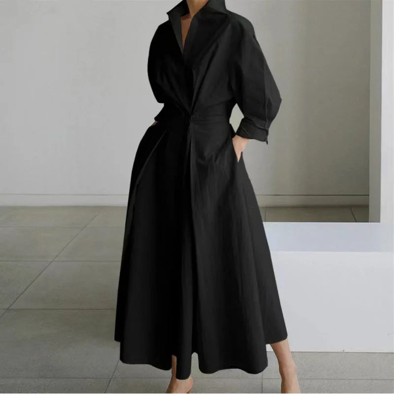 Close side view of the waist tie and gathered front wrap detail on a printed maxi shirt dress