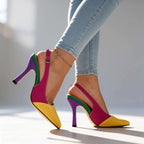 Yellow and magenta slingback pump with purple and green heel, styled crossed-leg pose against a light background
