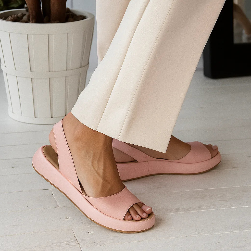 Pink platform slingback sandals shown from behind, highlighting the rounded heel cup and elasticated ankle strap.