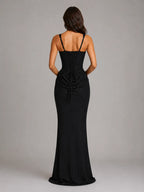 Back view of the black maxi dress showing the lace-up corset back and floor-length flared hem