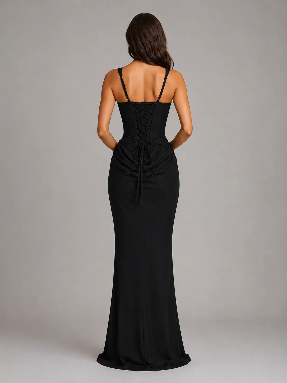Back view of the black maxi dress showing the lace-up corset back and floor-length flared hem