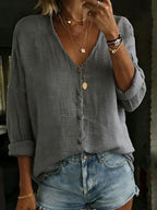 Grey cotton linen blouse with visible woven texture, button placket and casual oversized silhouette.
