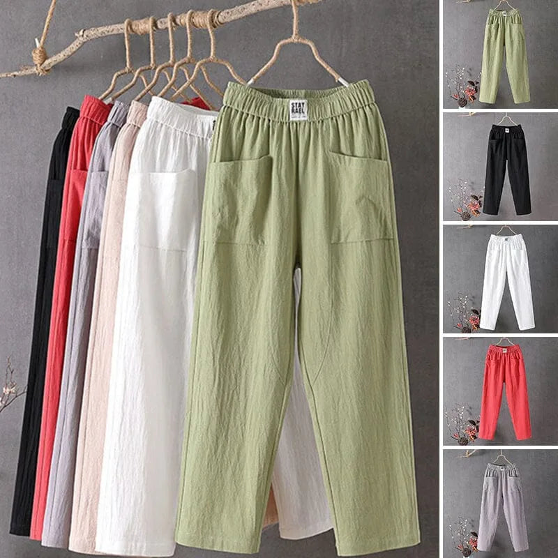 Six colourways of elastic-waist cotton linen pants hanging together, showing green, black, white, pink, red and grey options