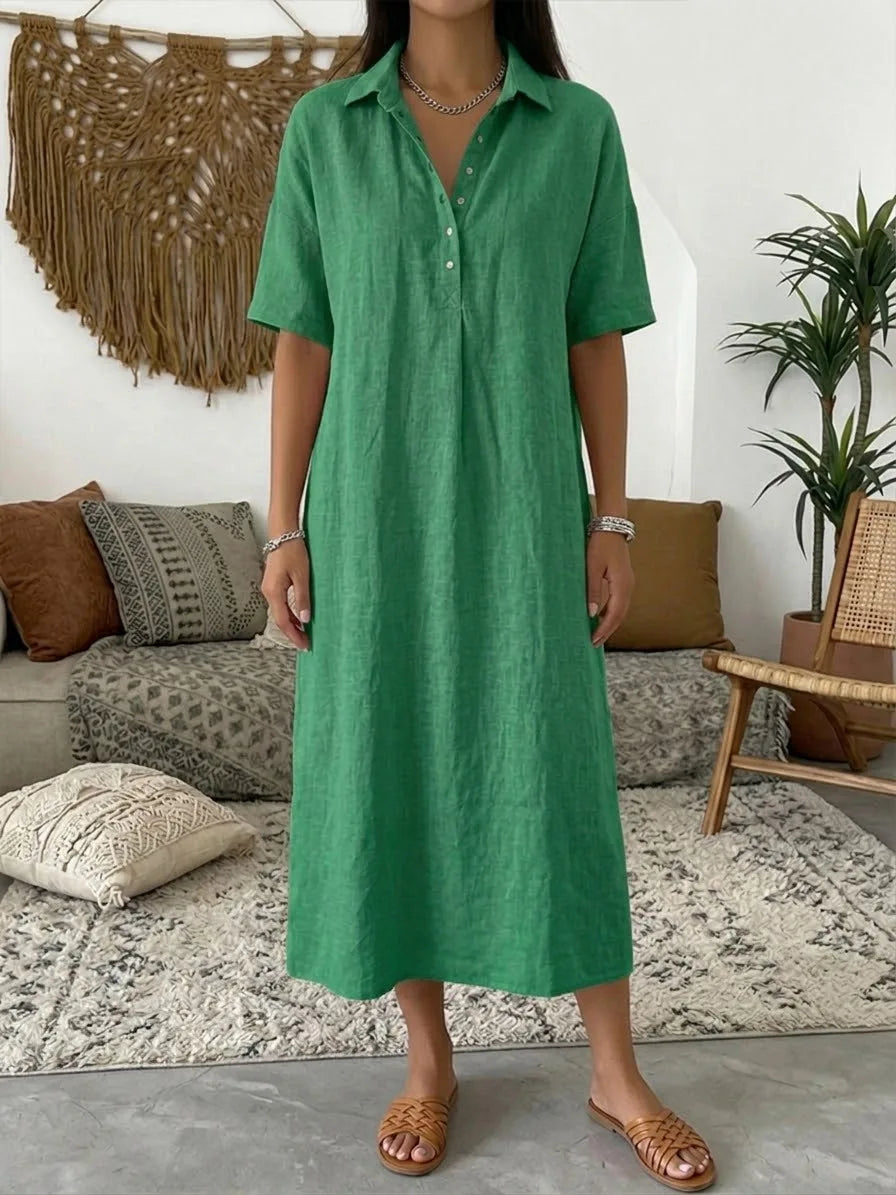 Green short sleeve polo maxi dress with collared V-neck shown on model standing on a patterned rug