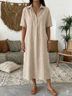 Sand beige polo dress with button front and collar, close view of the fabric texture and fit
