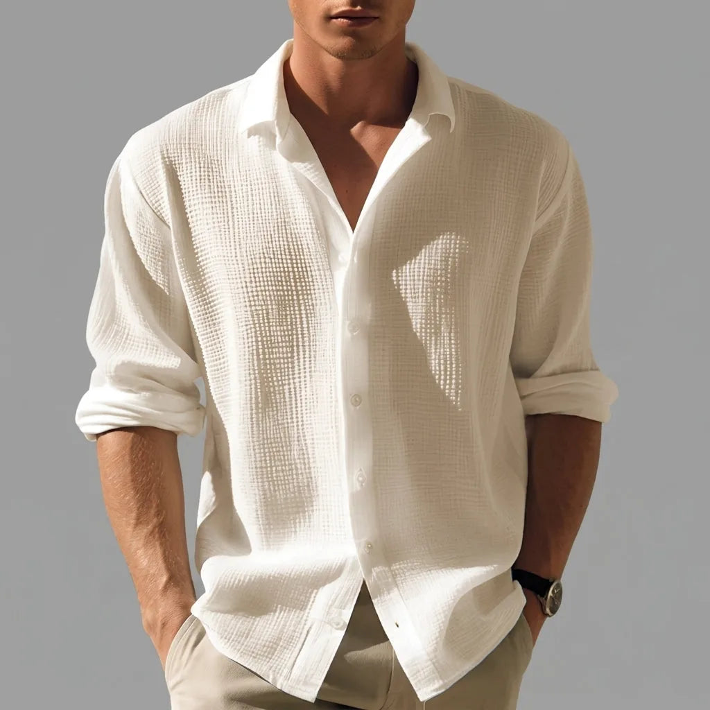 Front detail shot of the white crinkle-texture button-down shirt showing the open collar and mother-of-pearl style buttons