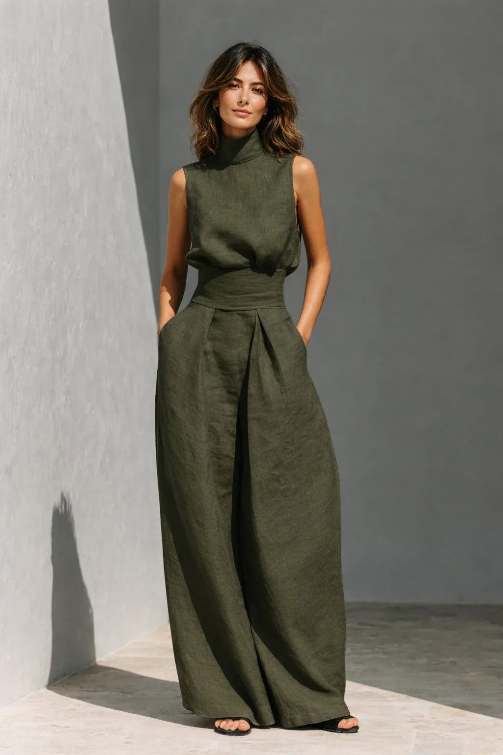 Front view of the minimalist linen co-ord in deep military green, showing the fitted waistband and flowing wide-leg trousers