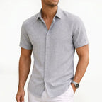 Light grey button-up shirt in a fine woven texture, shown with sleeve cuffs turned up