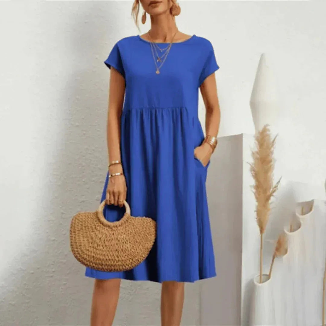 Close-up of the soft cotton fabric texture and relaxed cap sleeve on the casual summer dress