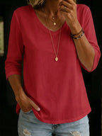 Coral red V-neck T-shirt with three-quarter sleeves, close-up view showing the ribbed V-collar and soft cotton texture