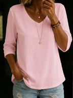 Blush pink V-neck T-shirt with three-quarter sleeves, close-up of the relaxed fit and curved shirttail hem