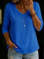 Close-up detail of the ribbed V-neckline and three-quarter sleeve cuff on a soft cotton casual T-shirt